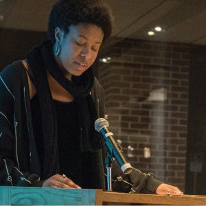 Student reading creative work at podium