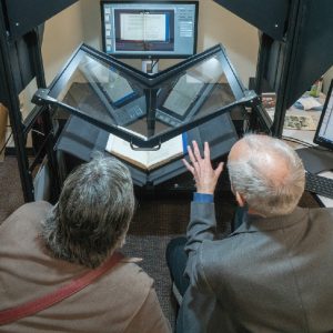 people looking at book scanner