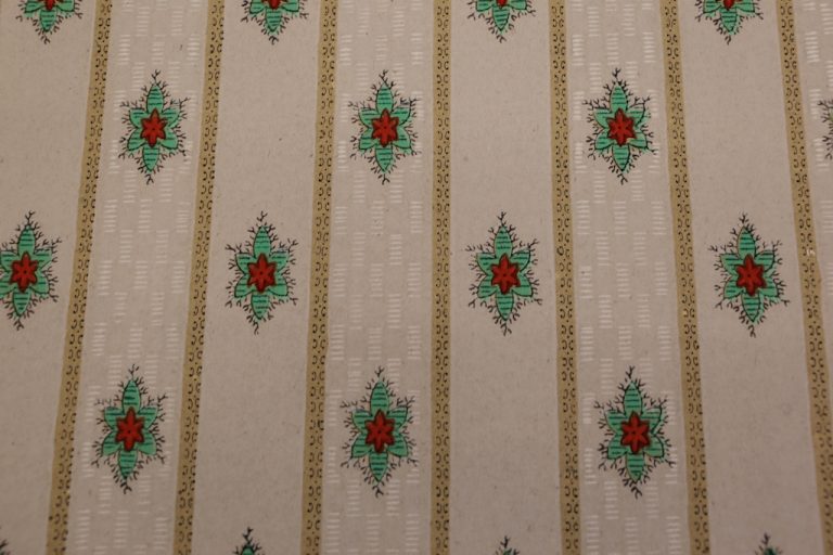 Image of wallpaper sample with bright green and red flowers