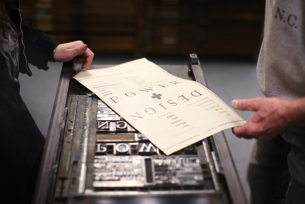 Photo of a broad sheet on top of the letterpress that printed it