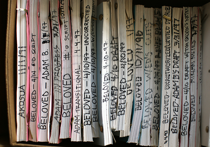 A box of bound documents spines facing out, labeled "Beloved" with dates, most of them in 1977