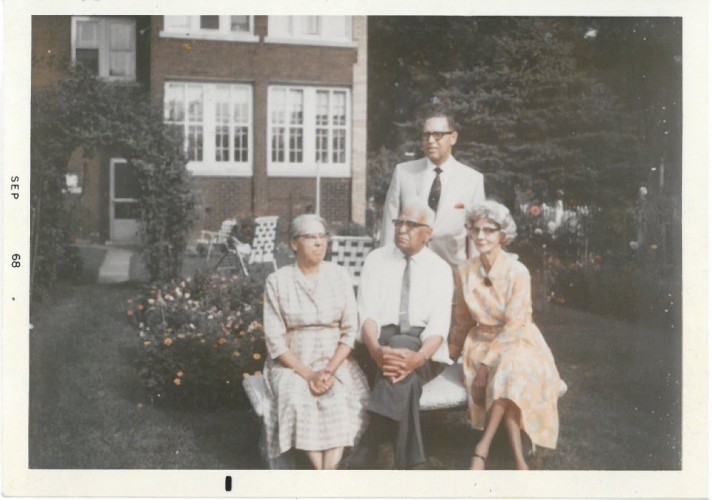 A family photo, taken outdoors, of W. A. and Mamie Thompson with their adult son and his wife