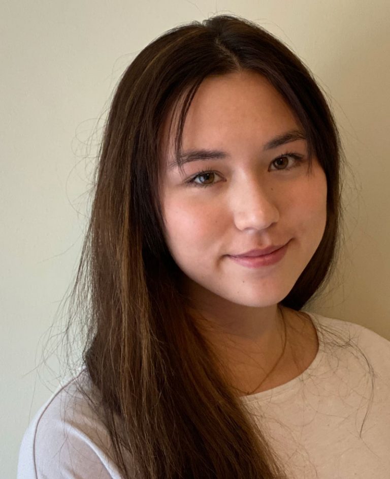 Photo of a smiling woman with long brown hair